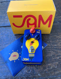 Jam Blue and yellow guitar pedal with red knob on a dark surface, featuring 'JAM' branding.