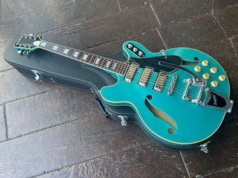 Eastwood blue metallic guitar, three pick-ups gold, with bigsby tremolo, rosewood fretboard with pearl block inlay, tortoise headstock