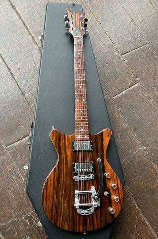 top view Ebony wood electric guitar, bigsby and chrome humbucker pick ups, with roswood neck and ebony wood headstock