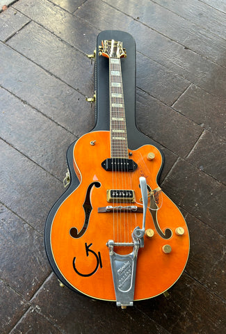 Gretch orange finish guitar with bigsby, two pick ups, gold control knobs, western motif inlays, brown Gretsch headstock