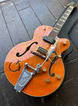 Gretch orange finish guitar with bigsby, two pick ups, gold control knobs, archtop metal bridge