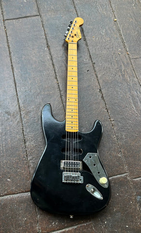 Black electric guitar Stratocaster style, with maple neck with black inlay markers, squier headstock 