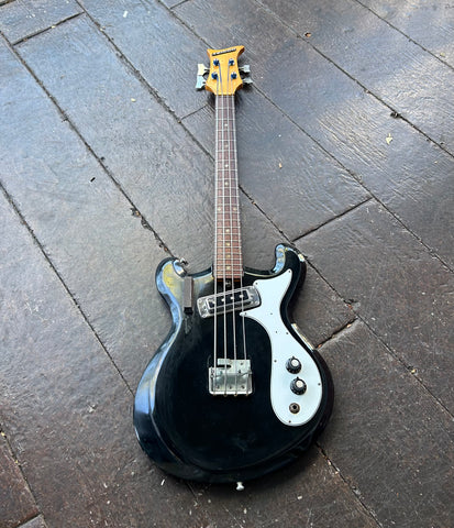 Black short scale bass with white pick guard, one black pick up, two control knobs, rosewood fretboard, maple headstock