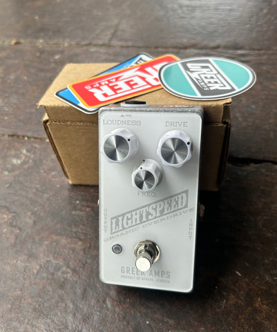 White Greer Overdrive peddal, with three metal knobs, one pushbutton metal switch 