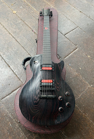 Black Gibson with red in finish, black and red pick ups, ebopny fretboard, with red skull fifth fret, black headstock