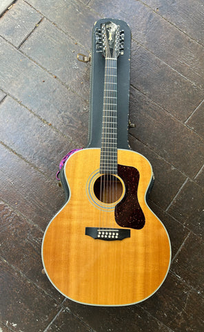 Spruce top jumbo Guild acoustic guitar, with dark  brown pickguard, rosewood bridge, rosewood fretboard with black headstock, Guild logo