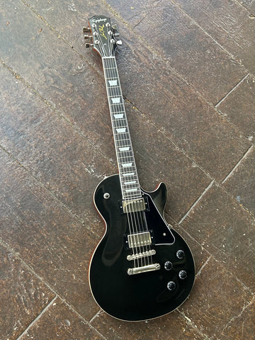 Black graphite fihish, chrome hardware and pick ups, four black knobs, ebony fretboard with  pearl trapezoid inlays and black headstock with Epiphone writing