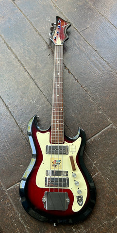 Burgunday bass with white pickguard, metal pick ups, three knob controls, rosewood fretboard with dot perl markers and burgundy red headstock