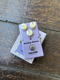 Pink blue NUX chorus pedal with three tan controls, single button footswitch