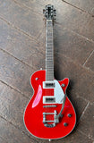Red Gretsch electromatic with silver pickguard, bigsby tremolo, roseood fretboard, bloack headstock. Black pickups, silver pick up rings