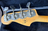Close up back of maple headstock with four in line metal tuners with Getty Lee Signature 