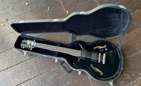 Top view Dean twelve string black with sound holes, with humbucker pick ups, rosewood fretboard