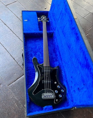 front view Guild black finish bass with to pick ups, chrome bridge, fretless rosewood fretboard with guild black headstock