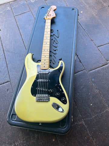 Top View Fender light green with black pickguard with maple fret board, black dot inlays, fender dark maple headstock