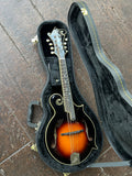 Top view mandolin sunburst in case with ebony fretboard and white dots with Loar black black headstock