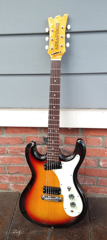 Front view: Brown sunburst, with white pick guard with rosewood fretboard, white dot inlays, with wood headstock, white button tuners