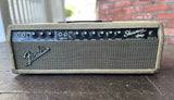 blond Fender showman guitar head amplifier head on a wooden surface with a blurred background