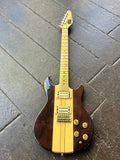Vox Electric guitar with wooden body and yellow pickguard on a tiled floor