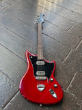 Red electric custom guitar with black pick guard and rosewood fretboard, black headstock