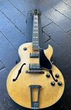 1981 Gibson Es 175 arch-top electric guitar in natural finish with rosewood fretboard and black headstock, on case displayed on wooden floor