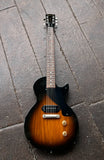 2005 Gibson Les Paul Junior sunburst finish, resting on a dark gray stone tile surface.