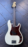 2008 Fender Precision bass white with tortoise shell pick guard and rosewood fretboard and maple headstock resting on wooden surface 