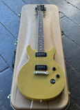 2015 Gibson Les Paul Special 100 TV Yellow electric guitar, black pick ups, rosewood fretboard on gold case displayed on wooden floor 