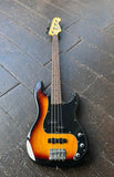 Squier PJ bass sunburst bass with rosewood neck , maple headstock resting on wooden floor