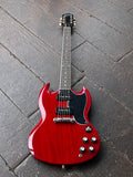 A red Epiphone SG electric guitar with a glossy cherry finish, black pickguard, two black P-90 pick ups and chrome hardware, photographed from above on a dark wooden plank floor.
