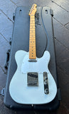 Fender American telecaster in off white with metal pickguard, maple neck resting on case displayed on wooden floor
