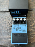 Blue Boss Super CH-1 Chorus with four knob controls on wooden surface