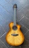 Breedlove acoustic guitar twelve string with myrtle wood, rosewood bridge and fretboard and brown headstock on wooden floor 