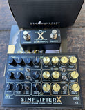 Black Guitar effects pedal with 'Simplifier X' branding on a wooden surface