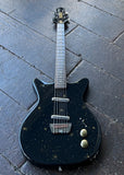 Danelectro Golden 1950s Electric Guitar - Black finish, gold sparkles with rosewood fretboard and black headstock on wooden surface