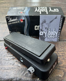 Black wah-wah guitar effects pedal with 'Cry Baby 535Q' packaging in the background.