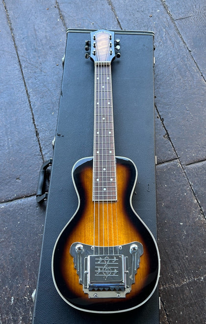 Gold Tone LS-6: Lap Steel Guitar in tobacco sunburst, chrome hardware, rosewood fretboard displaced on black case resting on wooden floor 