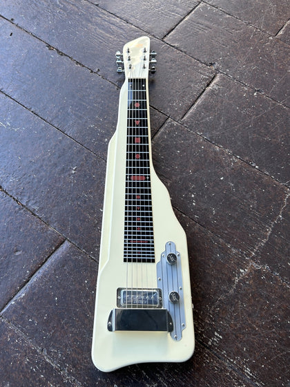 Gretsch electromatic lapsteel guitar in white, chrome hardware, black plastic fretboard and white headstock, displayed on wooden floor