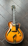 Hofner Jazzica Custom 2001 - Sunburst jazz guitar with ebony fretboard, black headstock resting on wooden floor