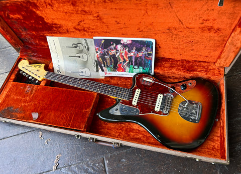 top view of Sunburs Fender Jaguar in case with rosewood fretboard an clay fret dots with maple headstock 