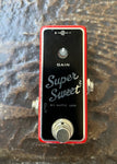 Xotic Super Sweet Boost guitar mini pedal with black front, red border, single button foot switch