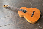 Top View: Custom acoustic redwood top with rosewood bridge,  black pick up sound hole, rosewood with walnut headstock