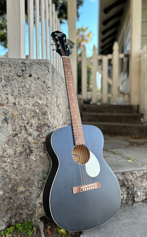 front view black acoustic guitat with white pick guard, wood bridge, rosewood fretboard with black headstock