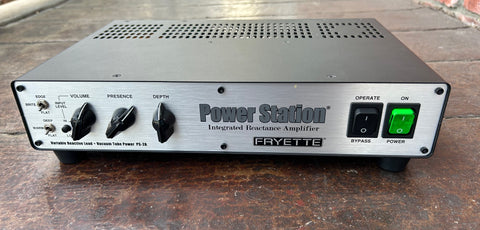front view Fryette Power Station, silver  metal front, three black control knobs, power and bypass button