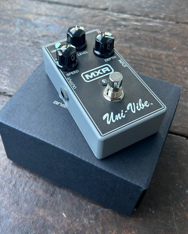 Black Uni-vibe pedal with grey and three black control knobs, single metal button switch