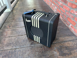 Black supro amp, front, white stripes  