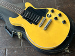 Close up, yellow faded Gibson Les Paul with black pick ups and black pickguard, rosewood fretboard with pearl dot inlays, black gibson headstock