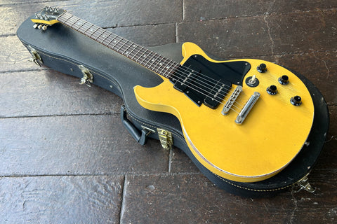Yellow faded Gibson Les Paul with black pick ups and black pickguard, rosewood fretboard with pearl dot inlays, black gibson headstock