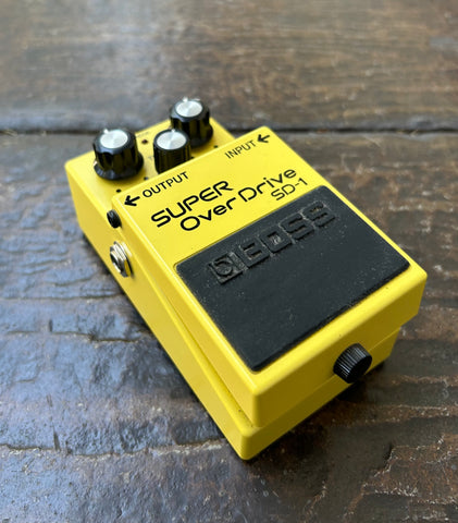 Boss SD-1 Super Overdrive. yellow guitar pedal, three control knobs