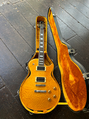 1997 Epiphone Les Paul electric guitar, with orange birds-eye maple top, rosewood fretboard, trapezoid inlays, black headstock