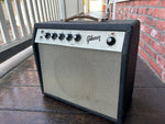 Gibson Amplifier with black enclosure and grey cover, metal control panel knobs